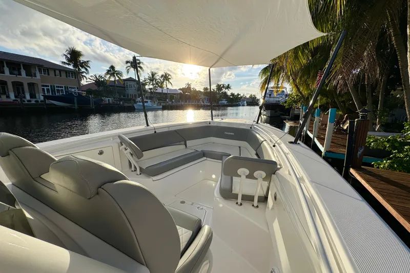 Slide: The Image of Interior view of 2021 Everglades 335 Center Console boat with scenic waterfront backdrop. - 21