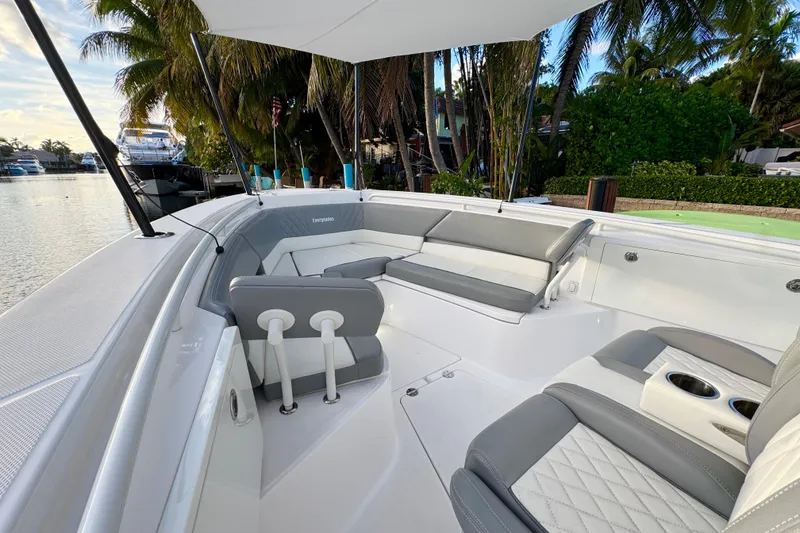 Slide: The Image of 2021 Everglades 335 Center Console boat with luxurious seating, docked by waterfront homes. - 22