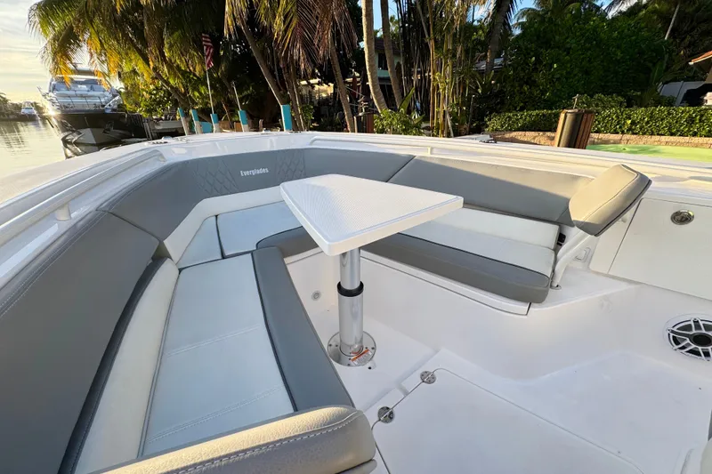Slide: The Image of 2021 Everglades 335 Center Console boat docked by a scenic waterfront. - 25