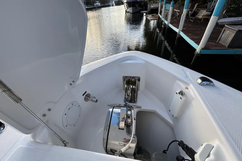 Slide: The Image of 2021 Everglades 335 Center Console boat interior with seating, docked by waterfront homes. - 27