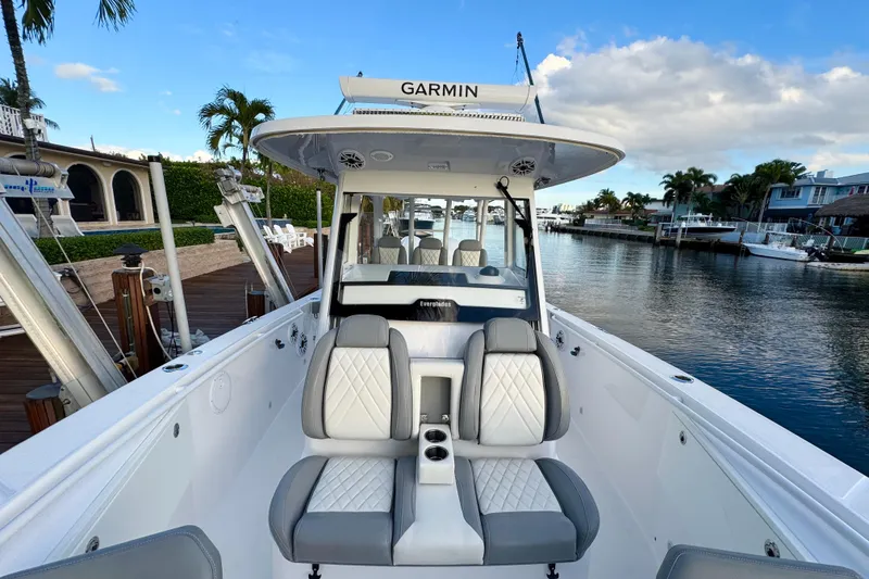 Slide: The Image of 2021 Everglades 335 Center Console boat docked by a scenic waterfront. - 30