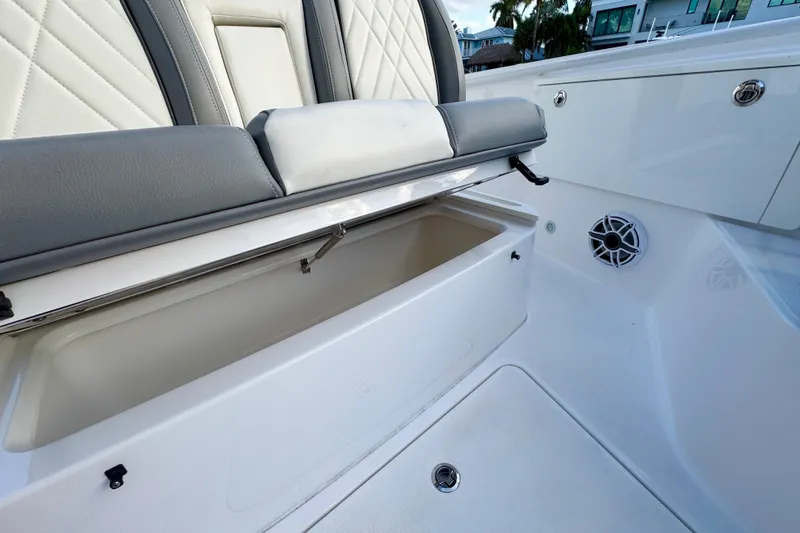 Slide: The Image of 2021 Everglades 335 Center Console boat interior with gray and white seating. - 32