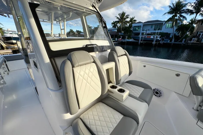 Slide: The Image of 2021 Everglades 335 Center Console boat interior with luxurious seating and waterfront view. - 37