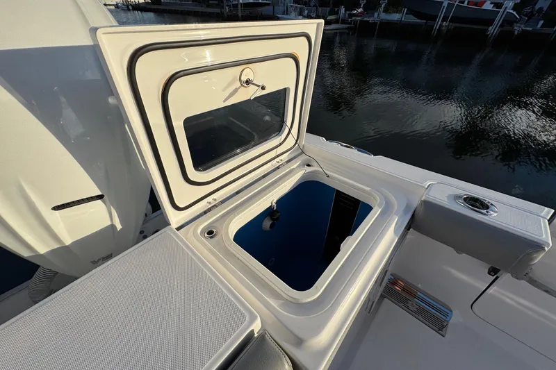 Slide: The Image of 2021 Everglades 335 Center Console boat docked by waterfront homes, featuring twin Yamaha engines. - 5