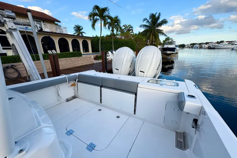 Slide: The Image of 2021 Everglades 335 Center Console boat docked in a scenic marina setting. - 6
