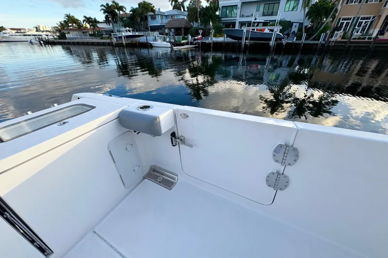 Slide: The Image of 2021 Everglades 335 Center Console boat docked in a scenic marina setting. - 7