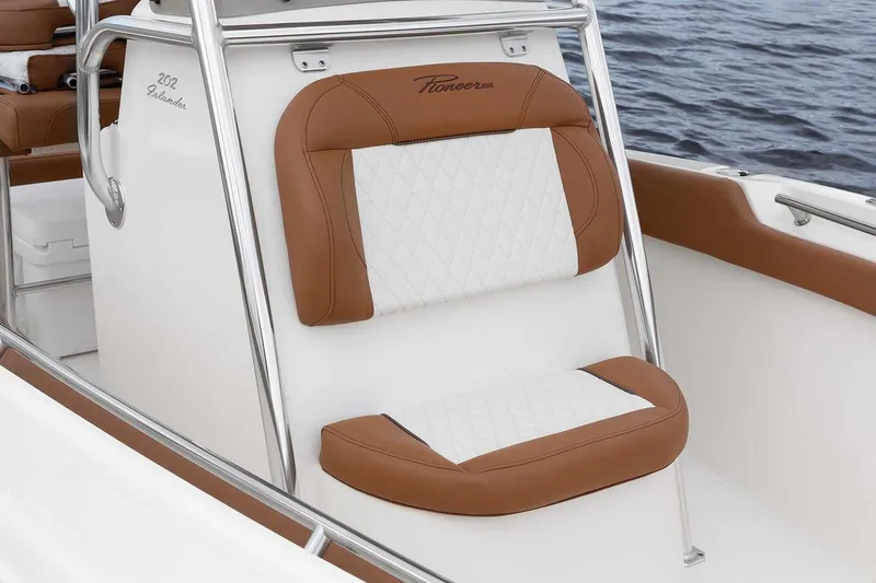 Slide: The Image of Manufacturer Provided Image: 2025 Pioneer 202 Islander boat seat with brown and white upholstery, on calm water. - 14