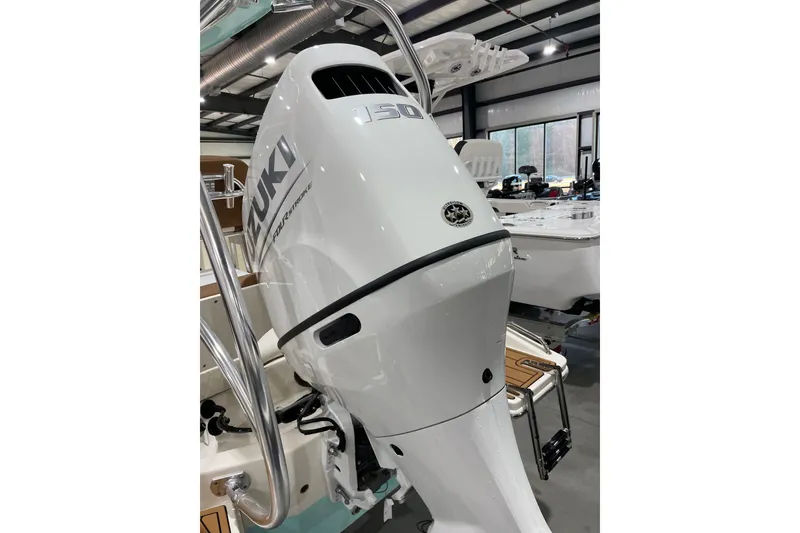 Slide: The Image of 2026 Pioneer 202 Islander boat with Suzuki outboard motor in showroom. - 2