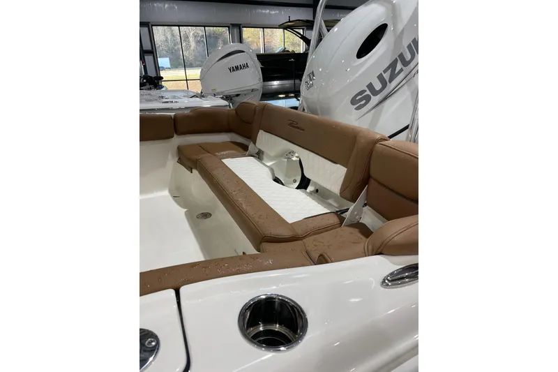 Slide: The Image of 2026 Pioneer 202 Islander boat interior with brown seating and visible Yamaha and Suzuki engines. - 3