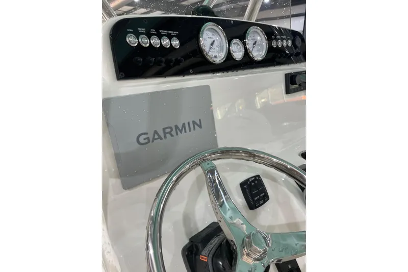 Slide: The Image of 2026 Pioneer 202 Islander boat dashboard with Garmin navigation and chrome steering wheel. - 4