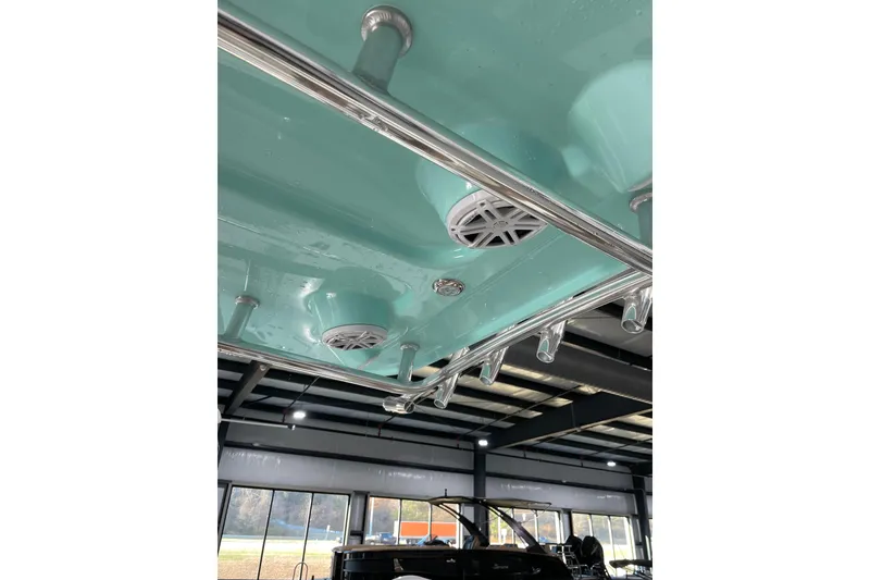 Slide: The Image of 2026 Pioneer 202 Islander boat interior with teal ceiling and mounted speakers. - 9