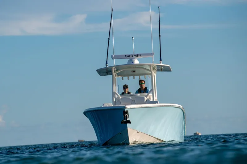 Slide: The Image of Manufacturer Provided Image: 2026 Jupiter 32 boat on open water, clear sky, Garmin equipment visible. - 2