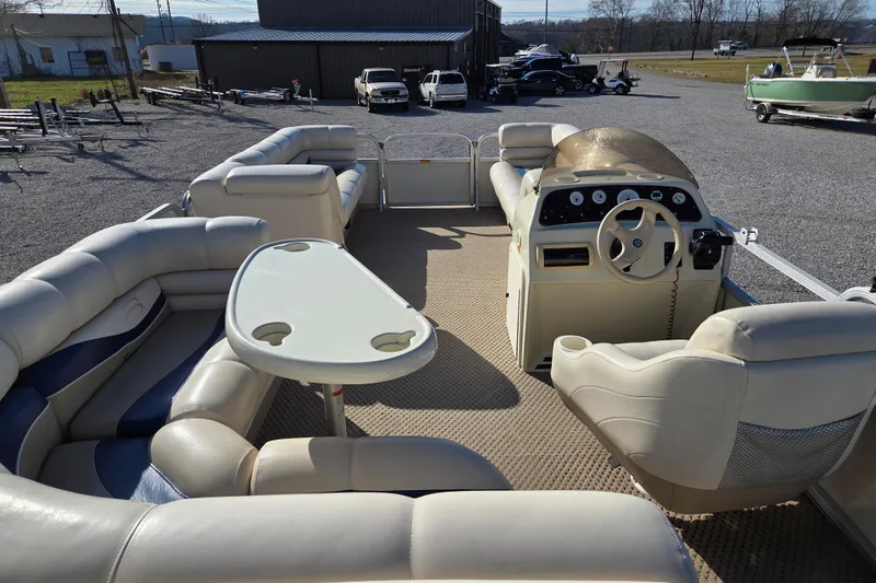 Slide: The Image of 2003 Bennington 2275LX pontoon boat interior with seating and steering console. - 10
