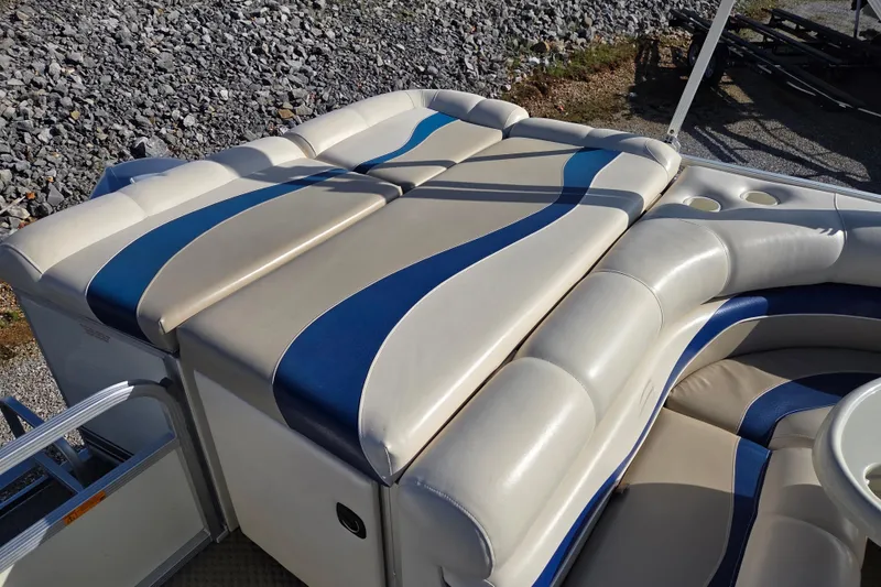 Slide: The Image of 2003 Bennington 2275LX boat with beige and blue cushioned seating. - 11