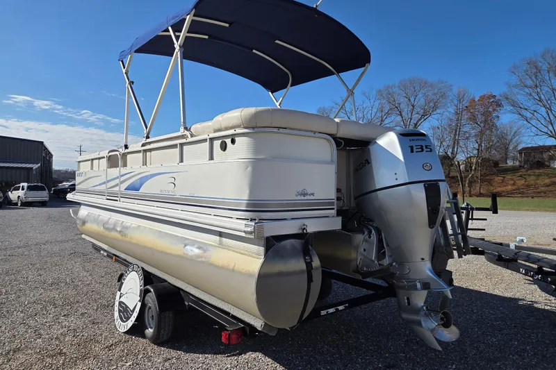 Slide: The Image of 2003 Bennington 2275LX pontoon boat with Honda 135 outboard motor on trailer. - 3