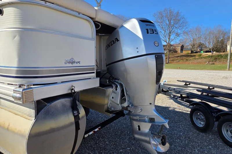 Slide: The Image of 2003 Bennington 2275LX pontoon boat with Honda 135 outboard motor on trailer. - 4