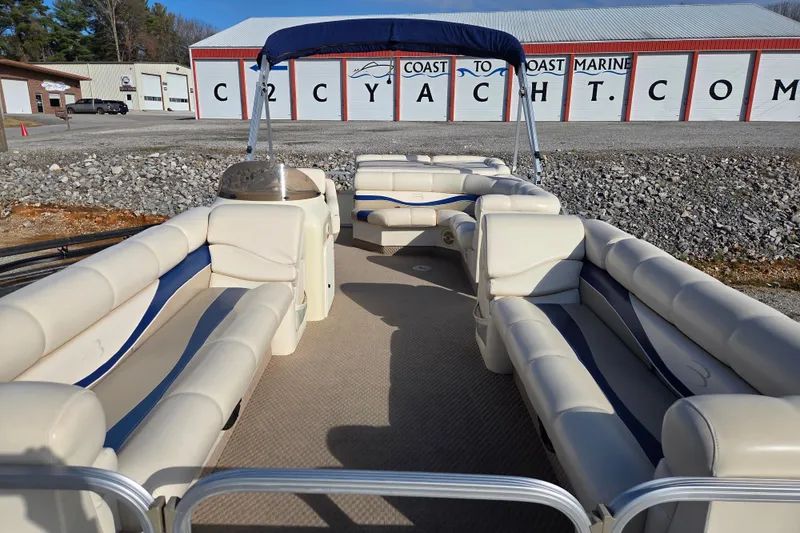 Slide: The Image of 2003 Bennington 2275LX pontoon boat with spacious seating, docked near Coast to Coast Marine. - 5