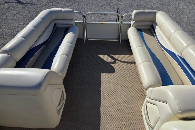 Slide: The Image of 2003 Bennington 2275LX pontoon boat interior with beige and blue seating. - 6