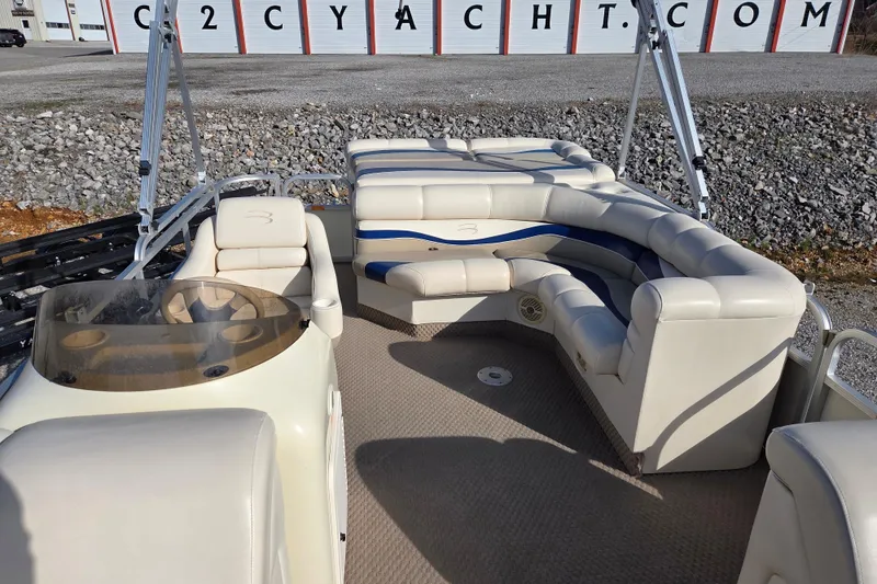 Slide: The Image of 2003 Bennington 2275LX pontoon boat interior with beige seating and helm. - 7