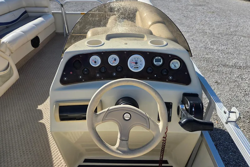 Slide: The Image of 2003 Bennington 2275LX boat dashboard with steering wheel and control panel. - 9