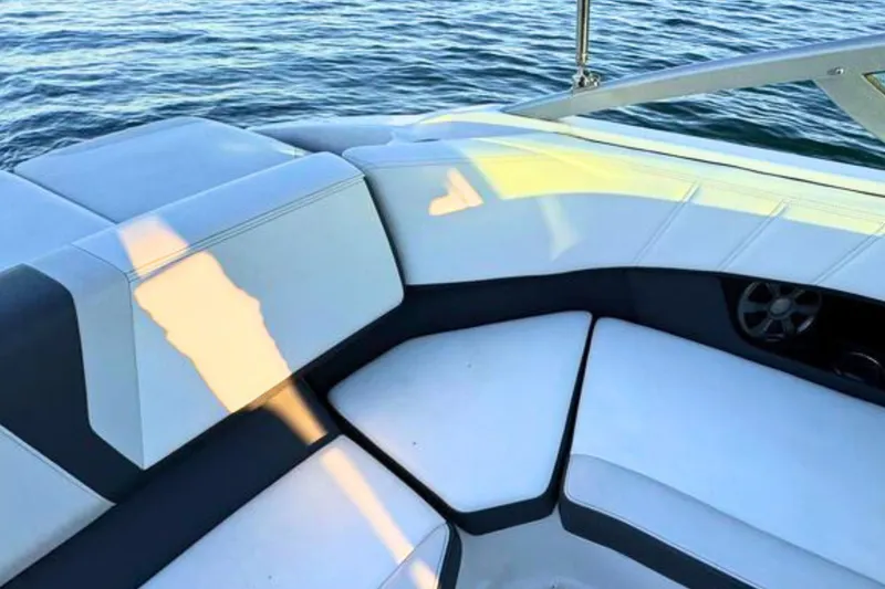 Slide: The Image of 2018 Regal 21 OBX boat interior with white seating and water view. - 10