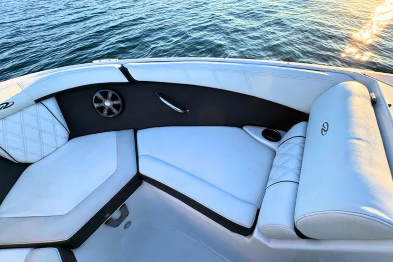 Slide: The Image of 2018 Regal 21 OBX boat interior with white cushioned seating and water view. - 19