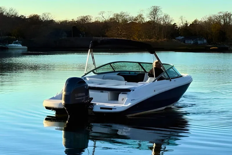 Slide: The Image of 2018 Regal 21 OBX boat on calm water at sunset. - 2