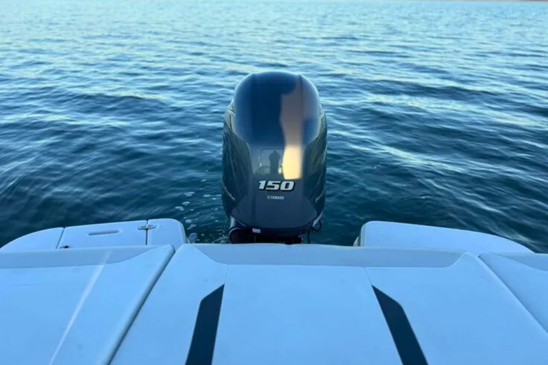 Slide: The Image of 2018 Regal 21 OBX boat with Yamaha 150 outboard engine on calm water. - 20