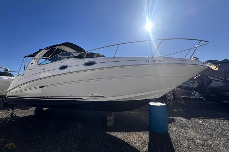 The Image of 2007 Sea Ray 280 Sundancer boat under bright sunlight, docked on land. - 0