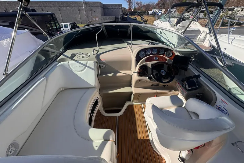 Slide: The Image of 2007 Sea Ray 280 Sundancer boat interior with helm and seating area. - 10