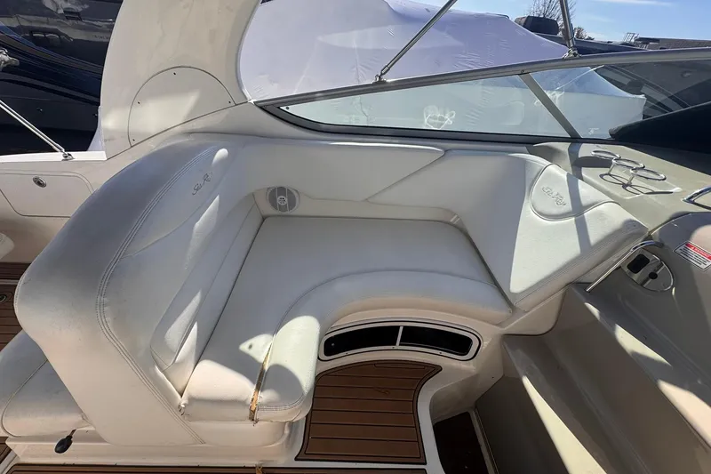 Slide: The Image of 2007 Sea Ray 280 Sundancer interior with white seating and wood flooring. - 12