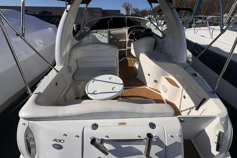 Slide: The Image of 2007 Sea Ray 280 Sundancer boat interior with seating and helm, showcasing luxury design. - 14