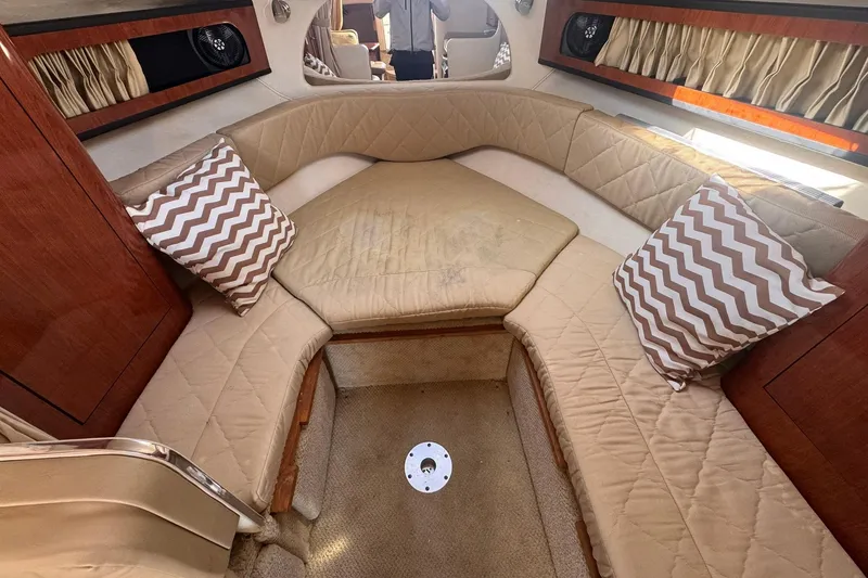 Slide: The Image of 2007 Sea Ray 280 Sundancer cabin interior with beige seating and chevron pillows. - 15