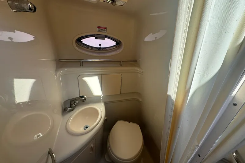 Slide: The Image of Compact bathroom in 2007 Sea Ray 280 Sundancer boat with sink and toilet. - 19