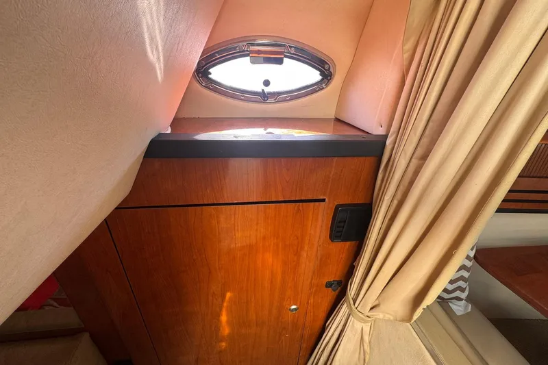Slide: The Image of Interior of 2007 Sea Ray 280 Sundancer with wood cabinet and porthole window. - 20