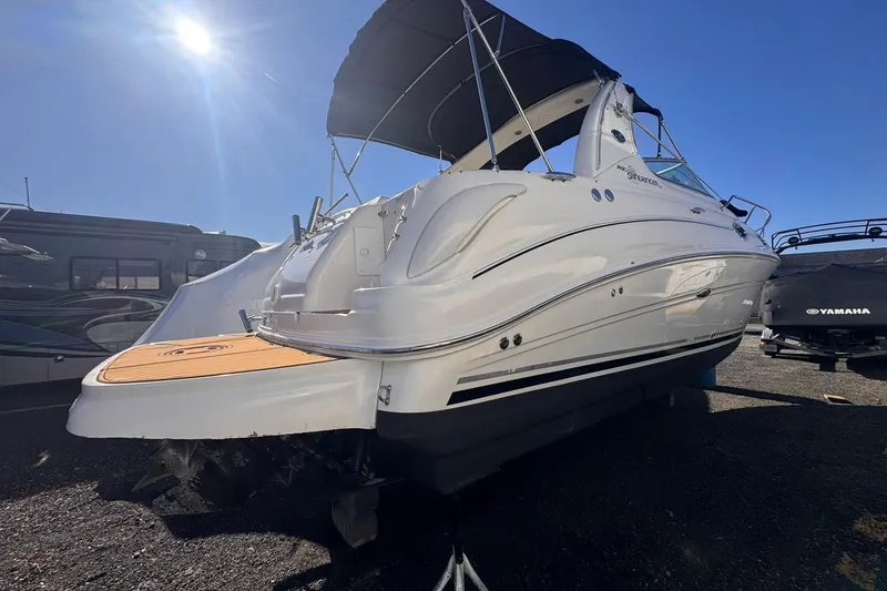 Slide: The Image of 2007 Sea Ray 280 Sundancer boat with canopy, parked under clear blue sky. - 3