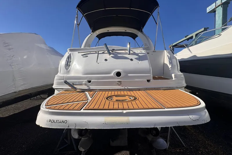 Slide: The Image of 2007 Sea Ray 280 Sundancer boat with wooden deck, docked under clear blue sky. - 5