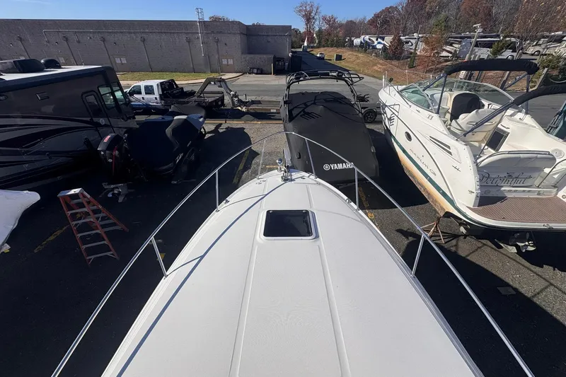 Slide: The Image of 2007 Sea Ray 280 Sundancer in a boatyard, surrounded by other vessels and vehicles. - 6
