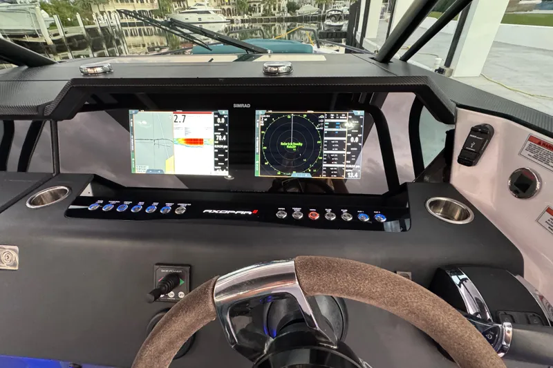 Slide: The Image of 2021 Axopar 37 boat dashboard with advanced navigation displays and controls. - 10