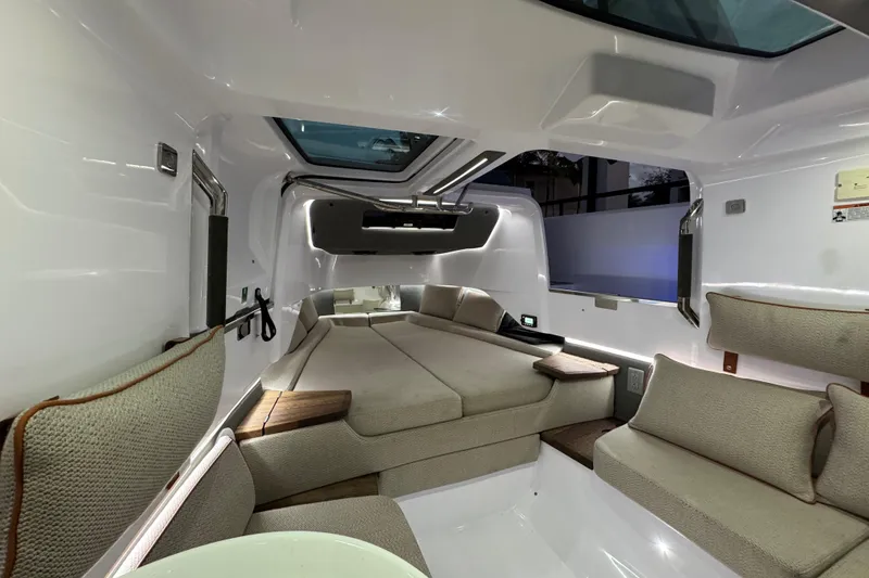 Slide: The Image of Luxurious interior of 2021 Axopar 37 Sun Top boat with modern seating and skylight. - 13