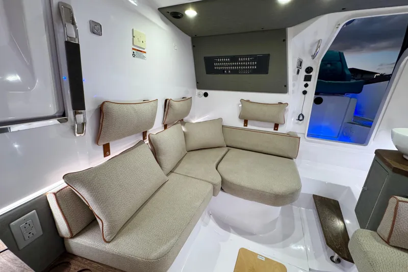 Slide: The Image of Interior of 2021 Axopar 37 Sun Top with beige seating and modern design. - 16