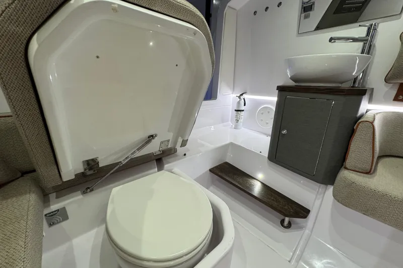 Slide: The Image of 2021 Axopar 37 boat interior bathroom with toilet, sink, and modern design. - 17