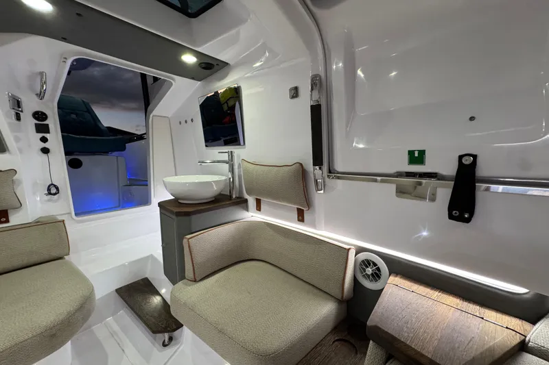 Slide: The Image of Luxurious interior of 2021 Axopar 37 boat with modern seating and sink. - 18