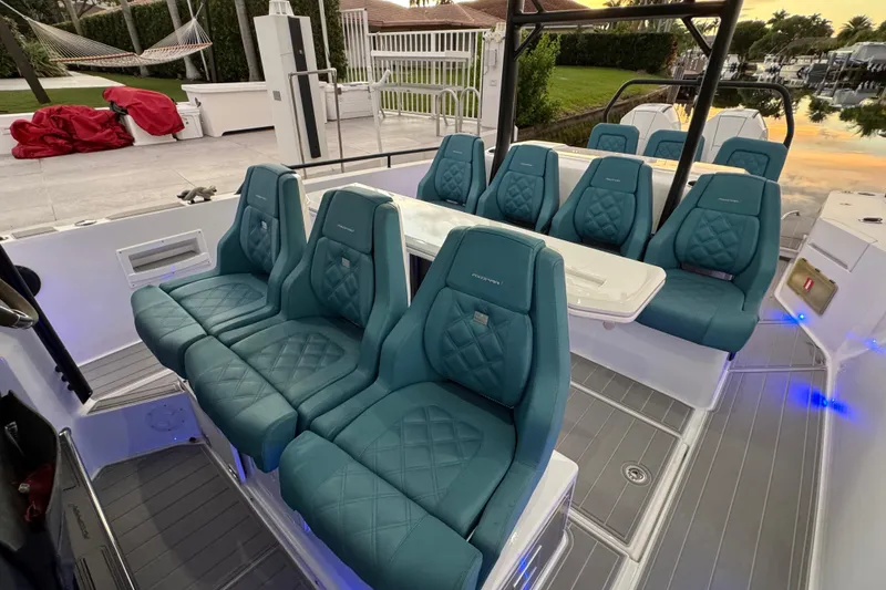 Slide: The Image of Luxurious seating on 2021 Axopar 37 boat with teal upholstery and modern design. - 19