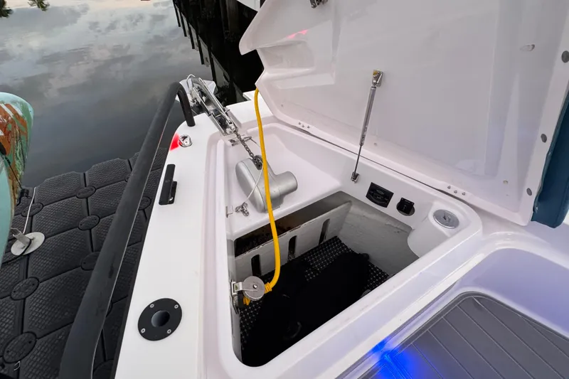 Slide: The Image of Open storage compartment on 2021 Axopar 37 boat, dockside view. - 22