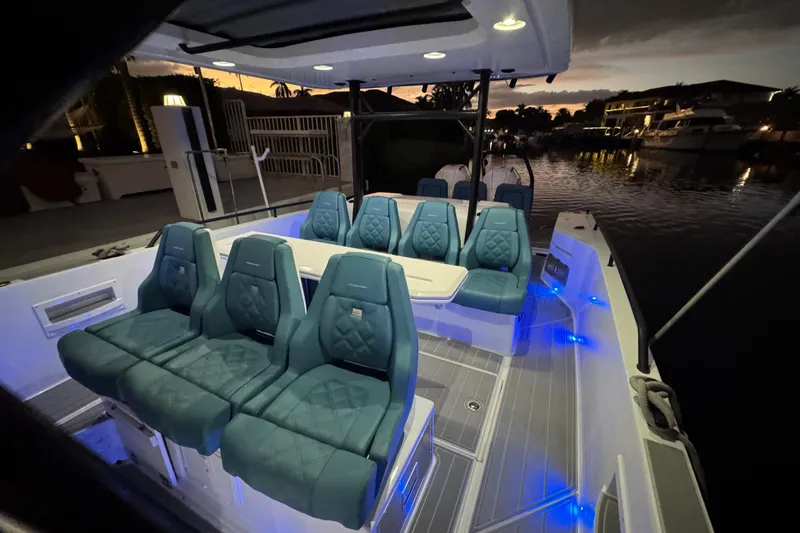Slide: The Image of Luxurious 2021 Axopar 37 boat interior with elegant seating and ambient lighting at dusk. - 27