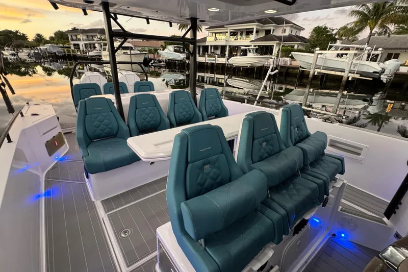 Slide: The Image of 2021 Axopar 37 Sun Top boat interior with luxurious seating and ambient lighting. - 8