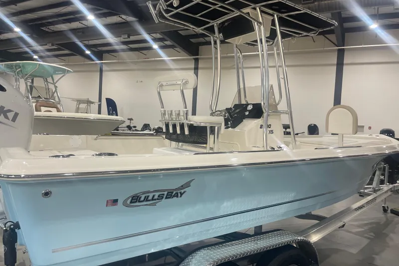 Slide: The Image of 2026 Bulls Bay 2200 XS boat displayed indoors on a trailer. - 10