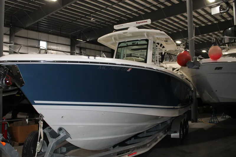 Slide: The Image of 2017 Boston Whaler 330 Outrage boat in indoor storage facility. - 2