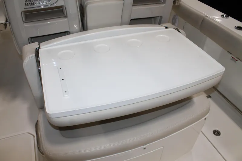 Slide: The Image of 2017 Boston Whaler 330 Outrage boat interior with seating and table setup. - 27